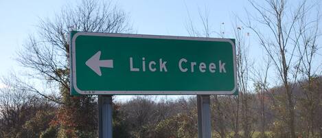 A directional sign for Lick Creek.