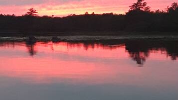 A calm lake with a reflection of the sky.
