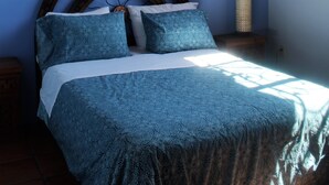 A bedroom with a bed, a ceiling fan, a window with curtains, and a nightstand. - Casita Tortuga, spacious 1BR1BA, roof terrace w view, walking dist to beach&town (Sayulita)