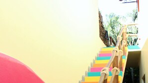A staircase with colorful steps and wooden handrails. - Casita Tortuga, spacious 1BR1BA, roof terrace w view, walking dist to beach&town (Sayulita)