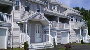 A row of townhouses with multiple balconies, a front porch, and a garage. - 3BR/2.5BA Eden Ridge, Great Location for Bethel & Sunday River (Bethel)