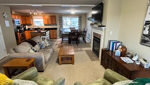 A living room with a sofa set, a coffee table, and a dining area with a table and chairs. - 3BR/2.5BA Eden Ridge, Great Location for Bethel & Sunday River (Bethel)