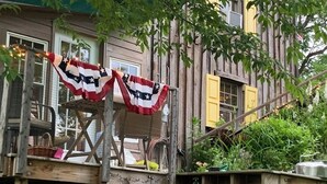 A rustic wooden deck with a staircase leading to a house. - Rustic, Artsy & Cozy Getaway Cabin in Laurel Highlands- minutes from Ligonier  (Ligonier)
