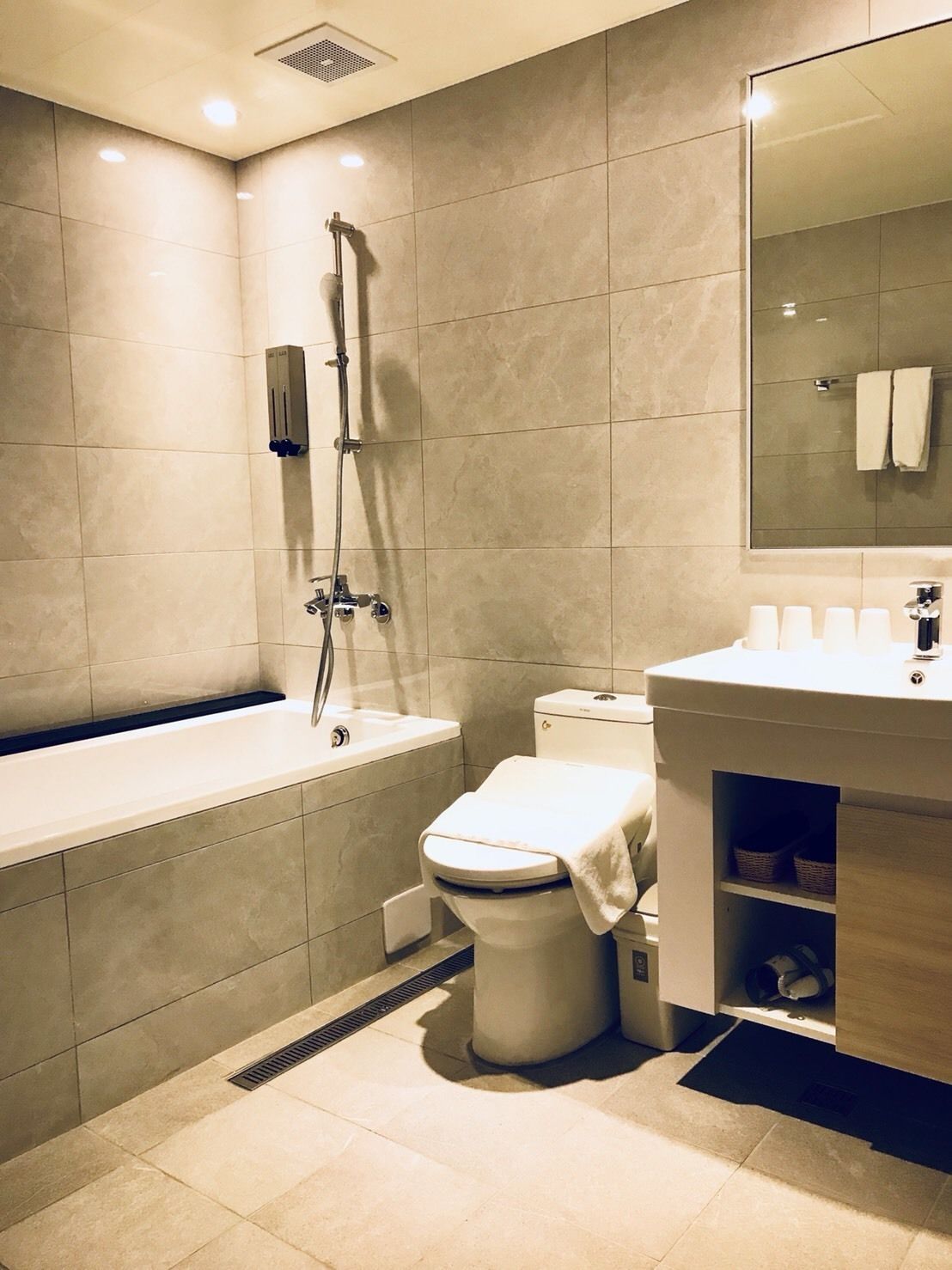 superior loft | bathroom | hair dryer, slippers, towels, shampoo