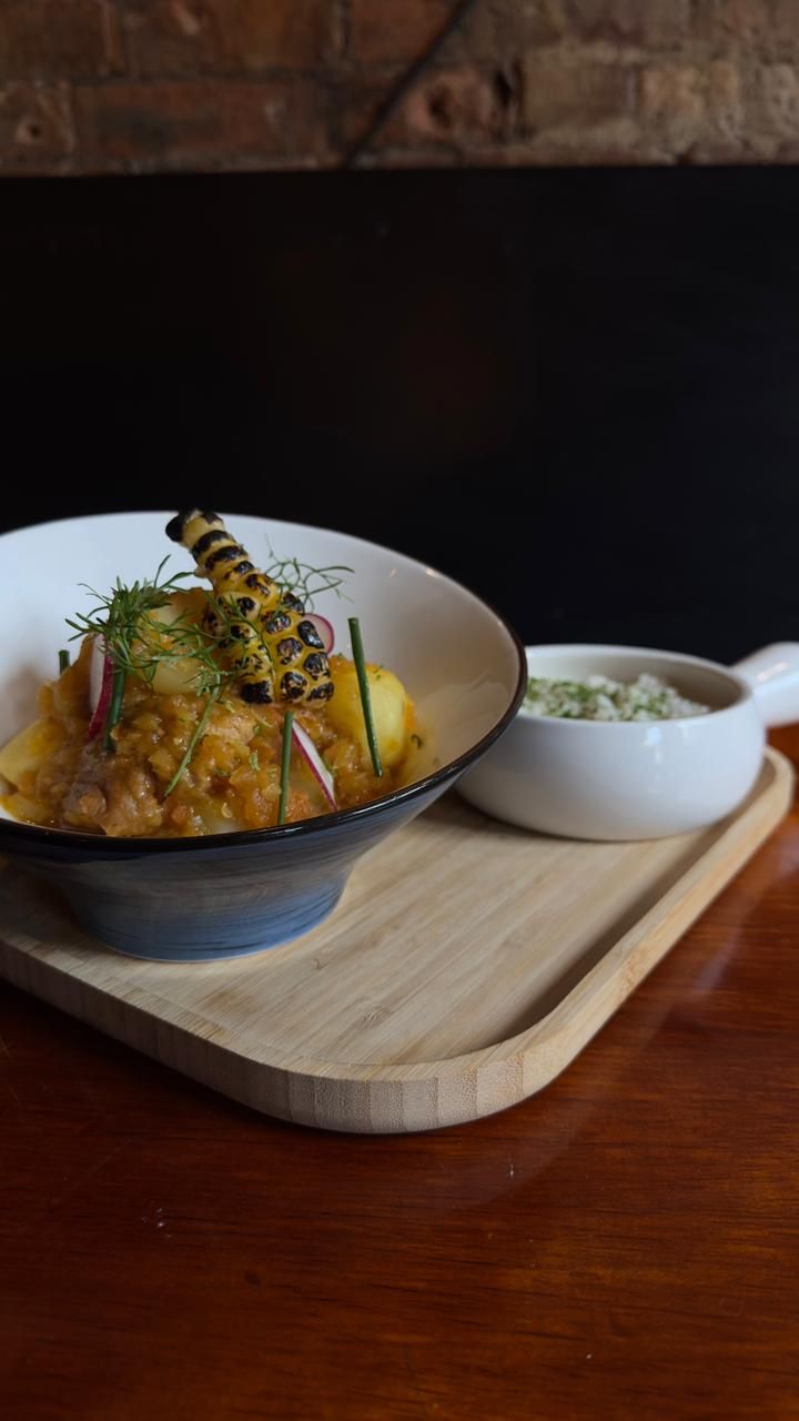 A bowl of food on a wooden tray.