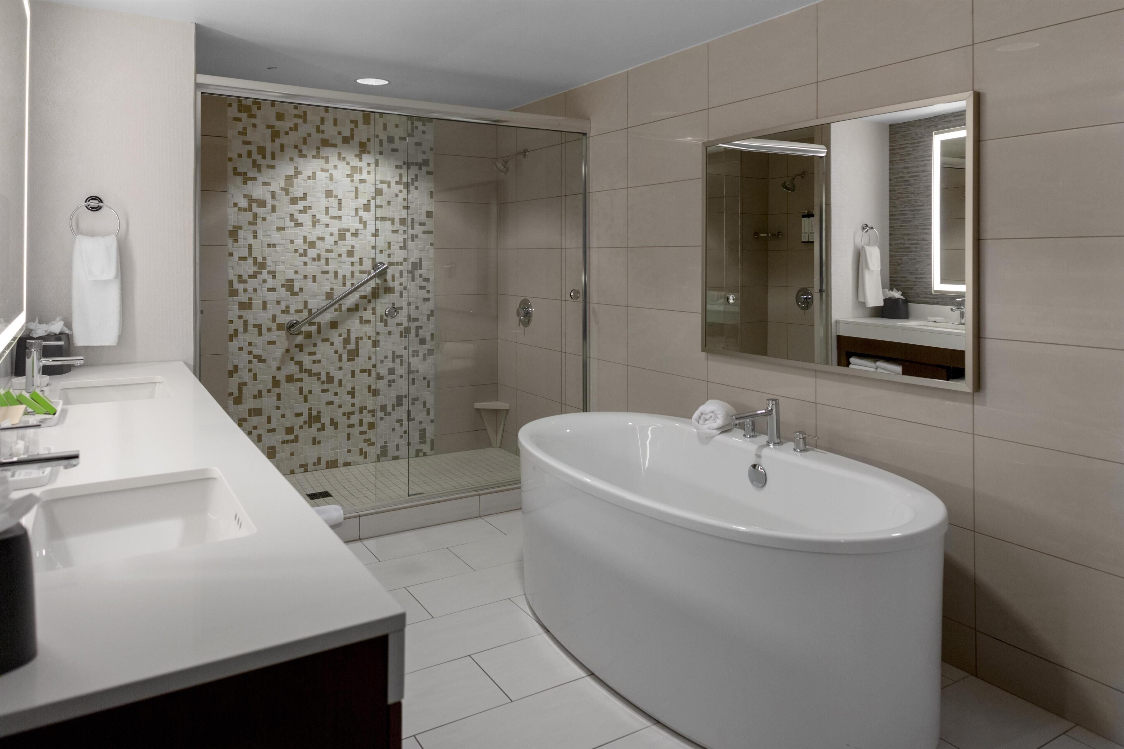 Shower, designer toiletries, hair dryer, towels