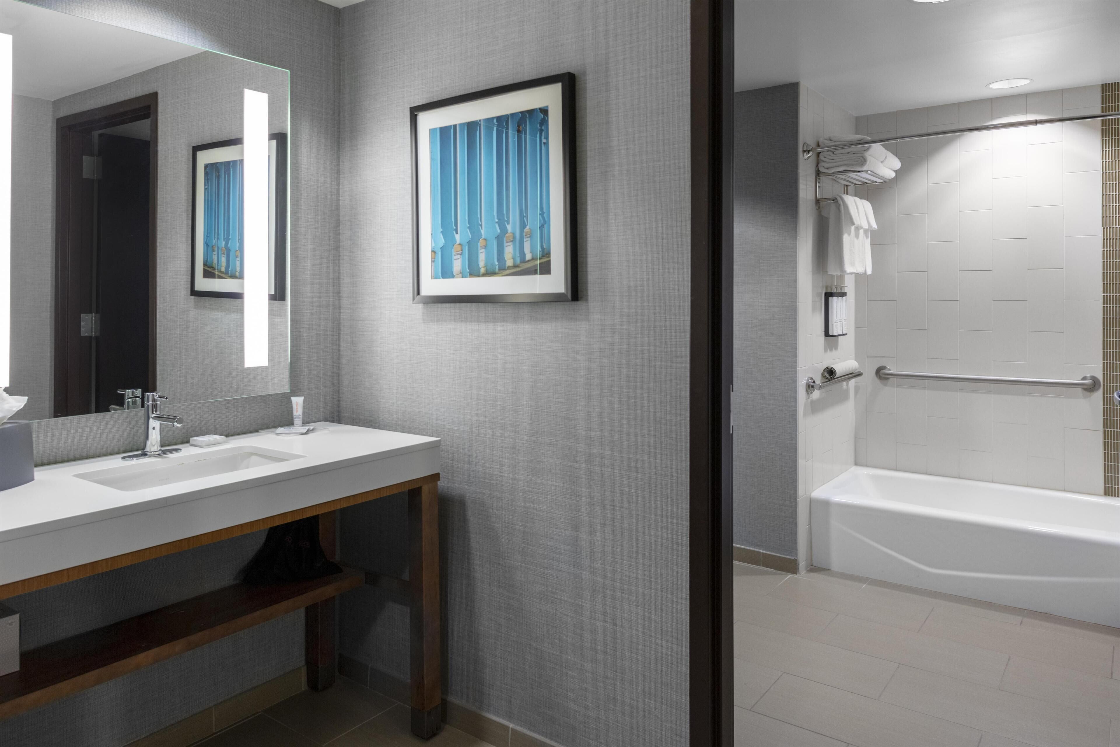 Shower, designer toiletries, hair dryer, towels