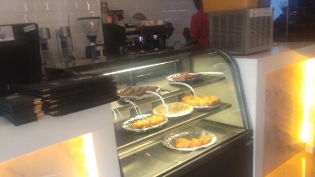 Un espace buffet avec un présentoir en verre contenant divers aliments.