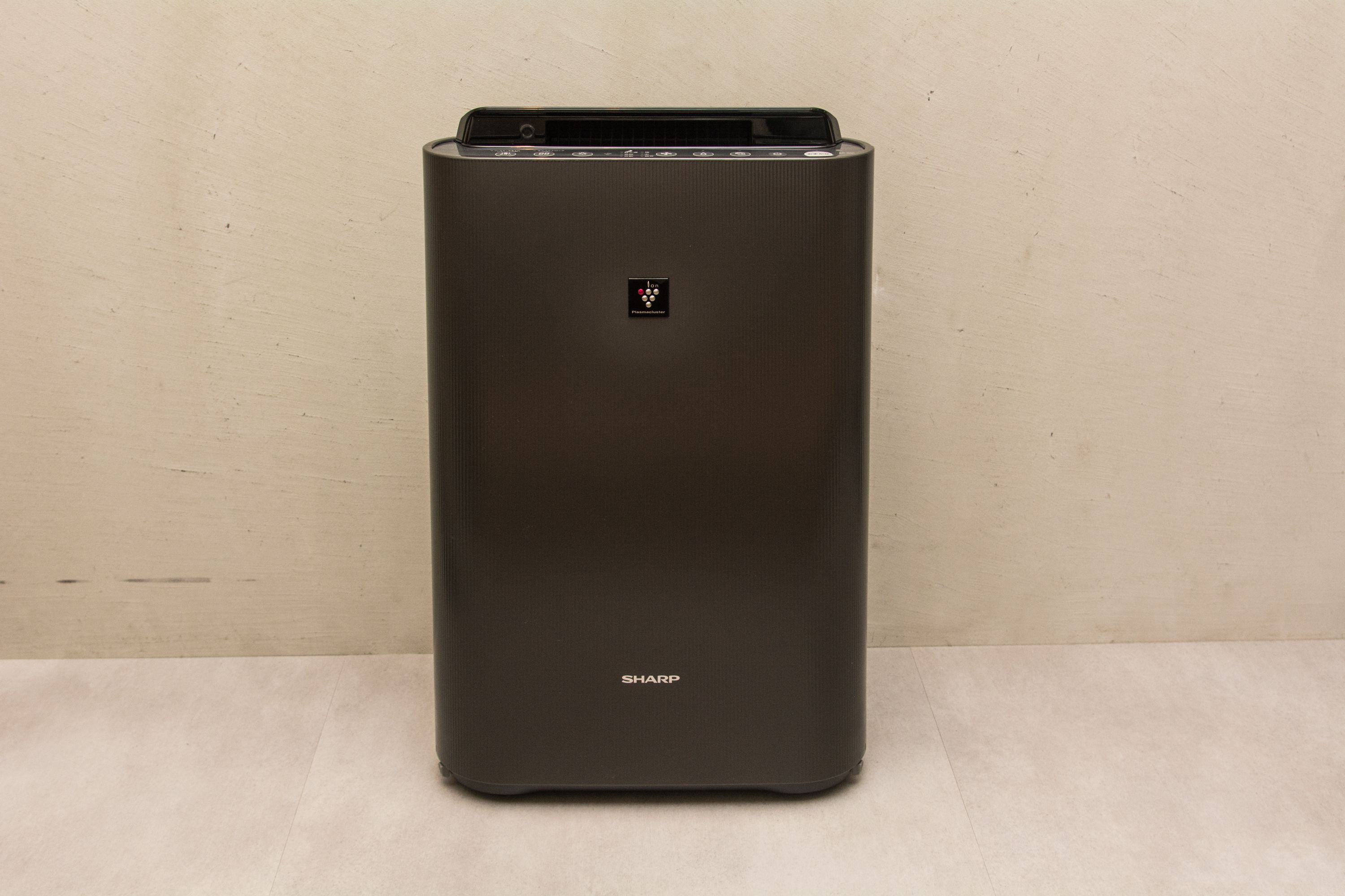 A black, rectangular, metallic object with a control panel and the brand name "SHARP" visible on the front.