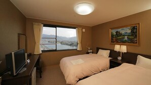 A hotel room with two beds, a desk with a TV, a window with a view of a cityscape, and a painting on the wall. - Hagi Royal Intelligent Hotel (Hagi)