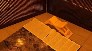 A room with a tatami mat floor, a low table with a cushion, and a traditional Japanese sliding door. - Hagi Royal Intelligent Hotel (Hagi)