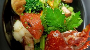 A bowl of seafood stew with various vegetables and herbs. - Hostellerie du Grand Sully (Sully-sur-Loire)