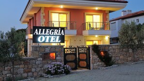A two-story hotel with a stone facade, balconies, and a sign reading "ALLEGRIA HOTEL". - Allegria Hotel (Cesme)