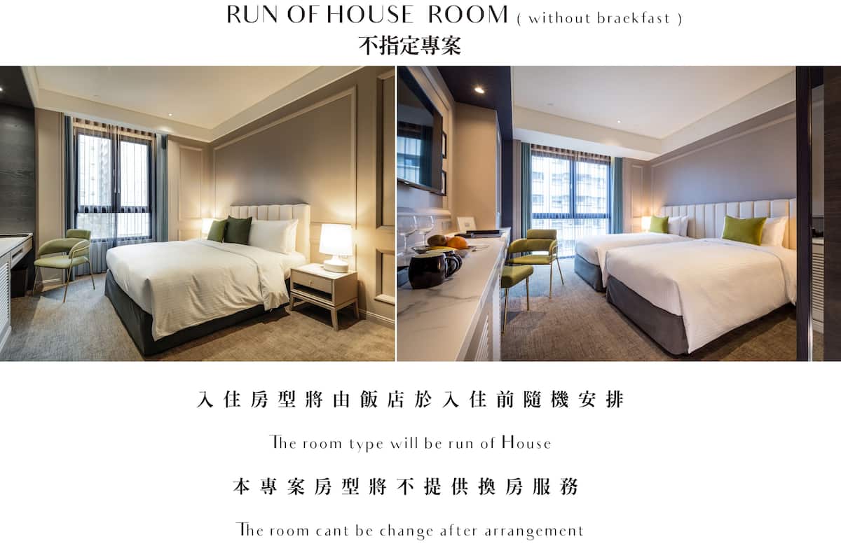 A hotel room with a bed, bedside table, lamp, chair, and a view of the city.