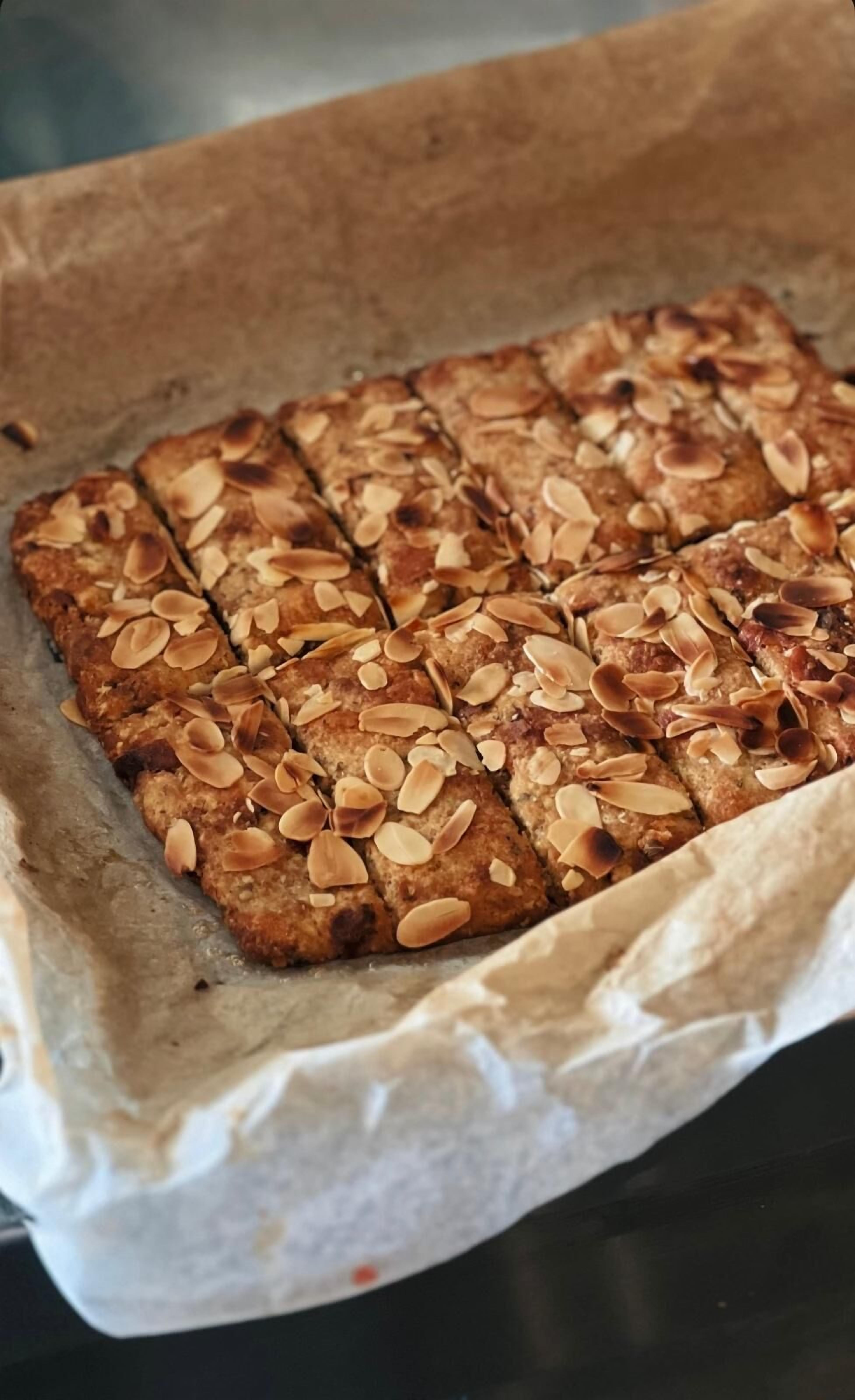A tray of sliced almond-topped bread.
