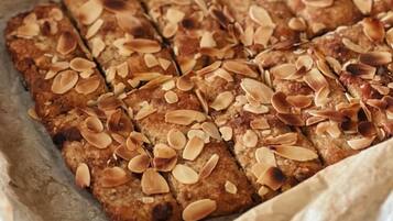 A tray of sliced almond-topped bread.