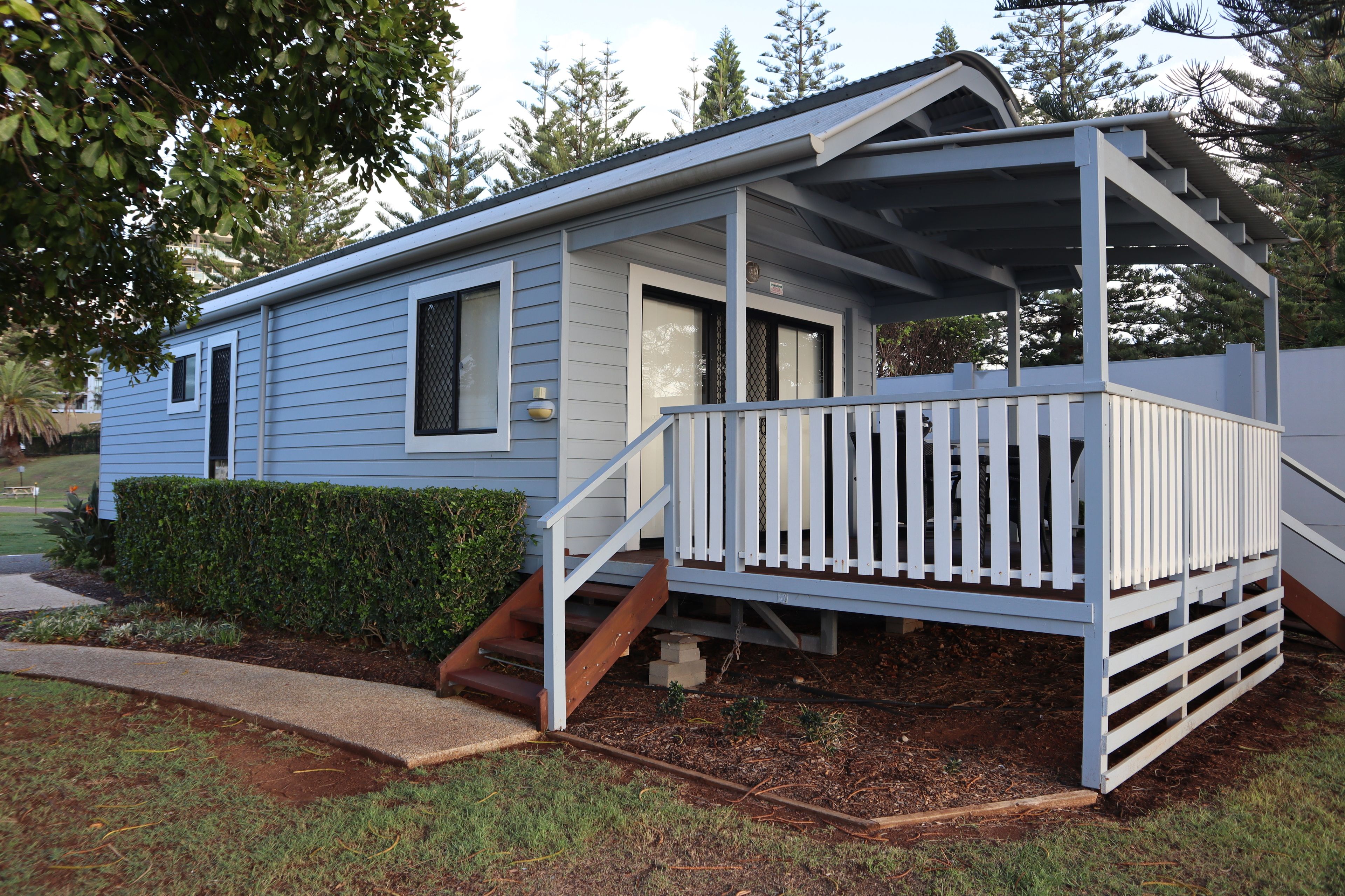 A single-story house with a covered porch and a small front yard.