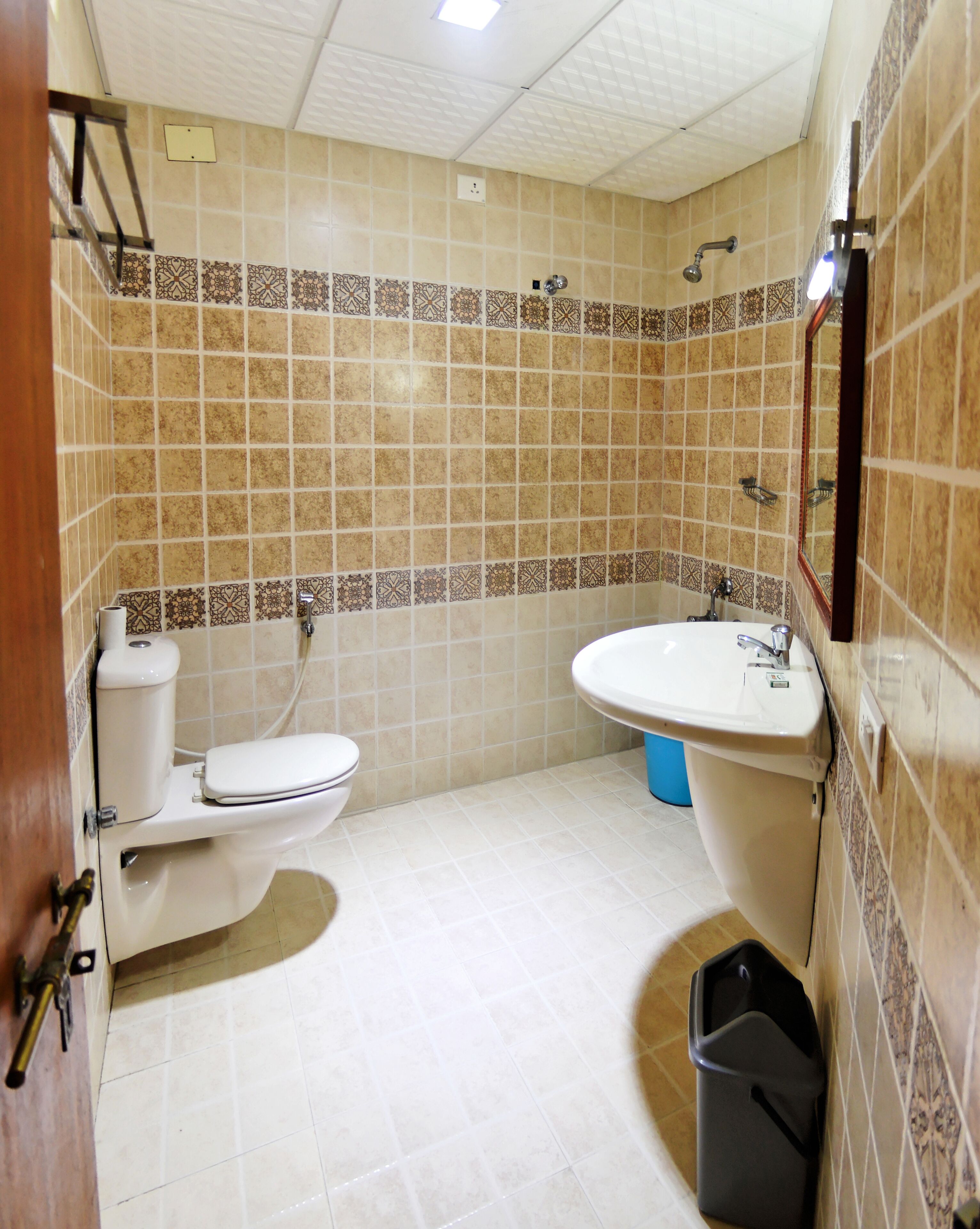 A bathroom with a toilet, sink, and shower.
