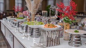 A buffet setup with various food items and decorative elements. - 7 Seven Sea Hotel  (Da Nang)