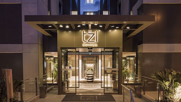A hotel entrance with a sign reading "TZ SUITES" and a glass door entrance. - Tzl Suites (Istanbul)
