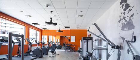 A gym with treadmills, elliptical machines, and weight machines.