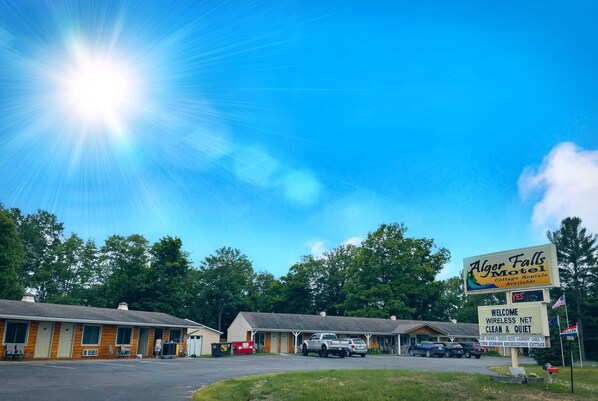 A motel with a signboard advertising "Alger Falls Motel" and "Cottage Rentals Available". - Alger Falls Motel (Munising)