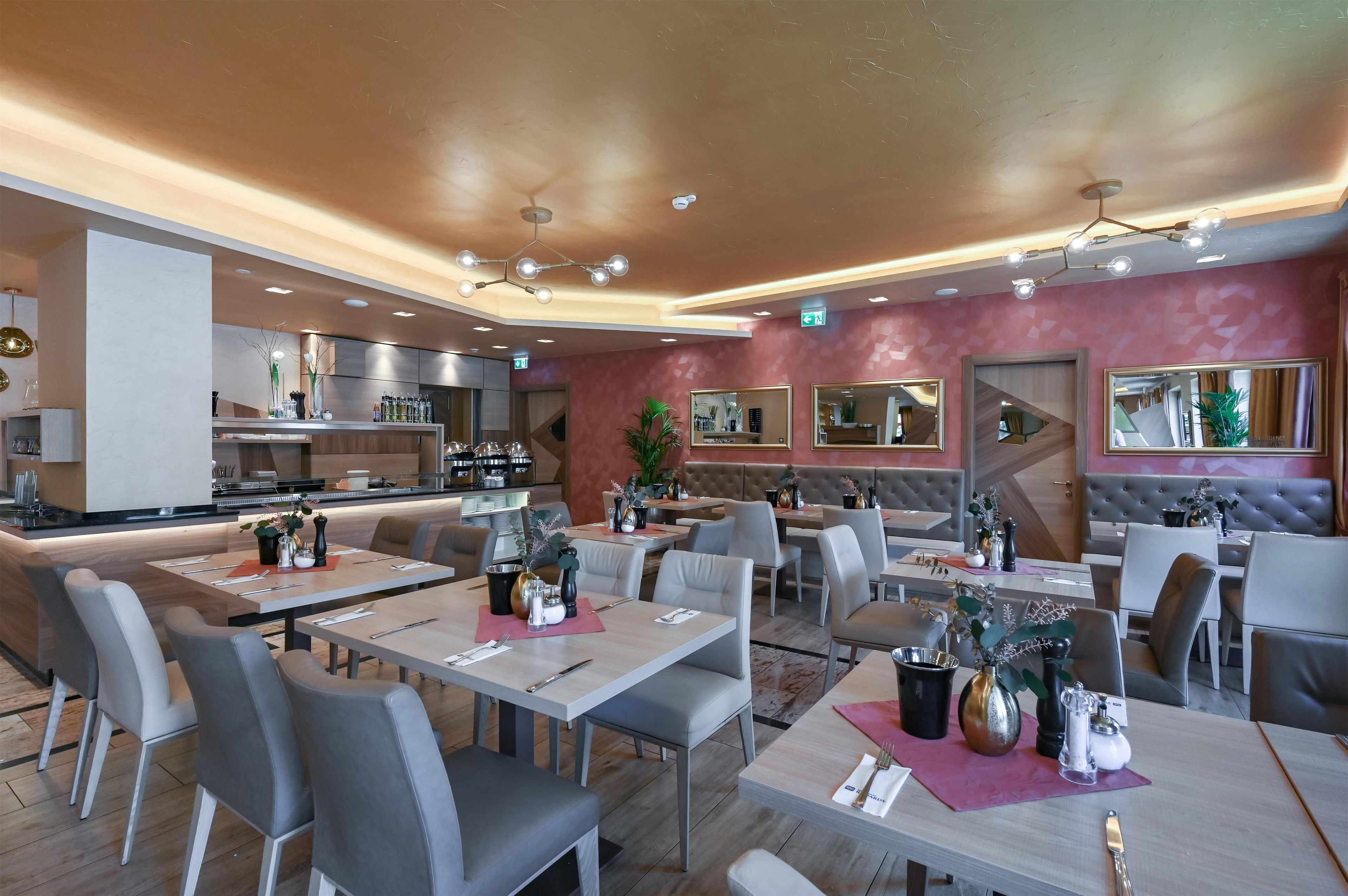 A modern restaurant with a central bar area, multiple dining tables, and a mix of seating options including booths and chairs.