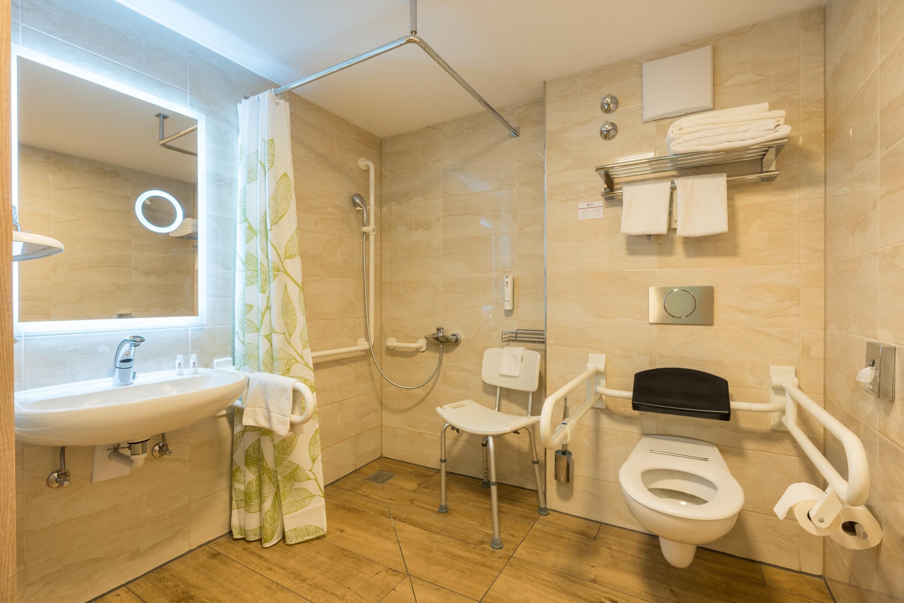 A modern bathroom with a shower, toilet, and sink.