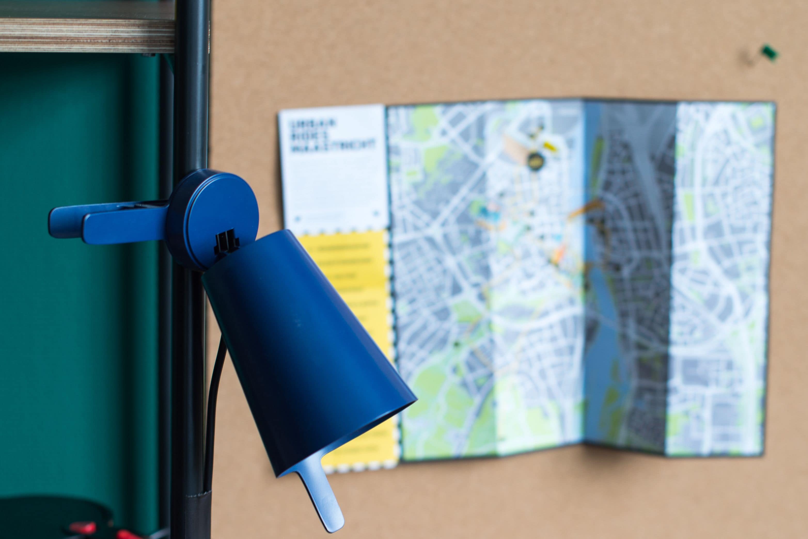 A blue object attached to a window, with a map in the background.
