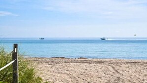 Beach nearby, white sand, beach umbrellas, beach towels