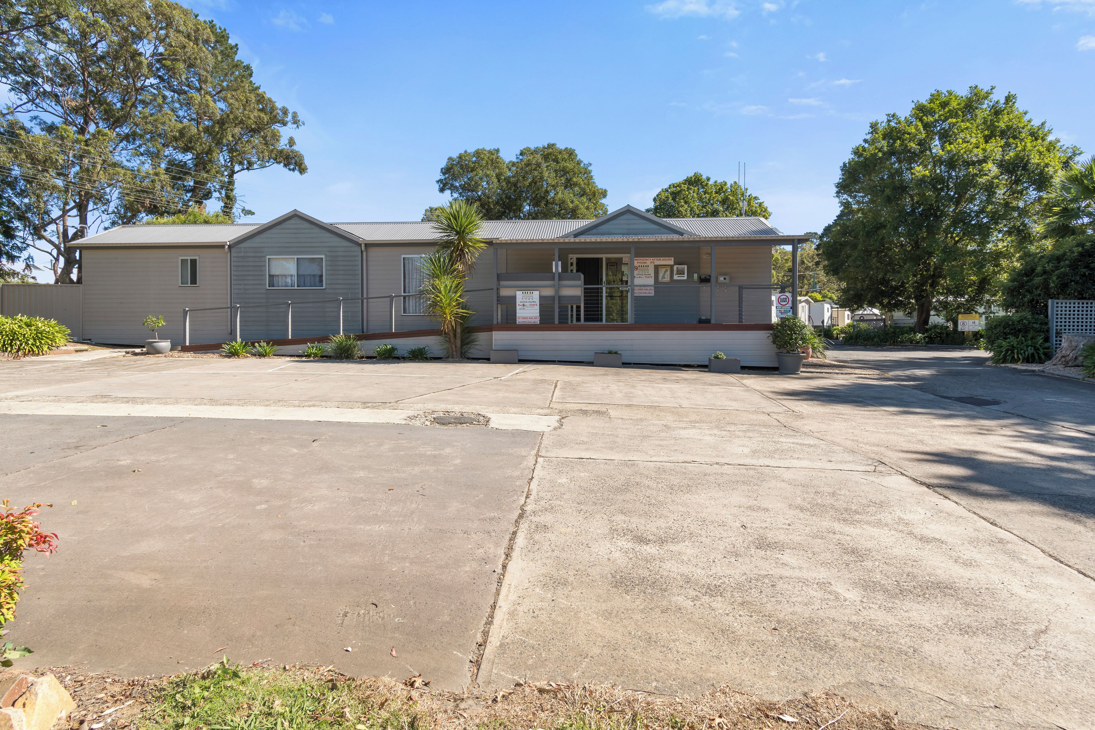 A single-story mobile home with a front porch and a small attached garage.