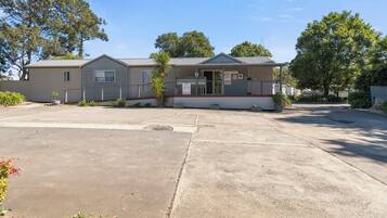 A single-story mobile home with a front porch and a small attached garage.