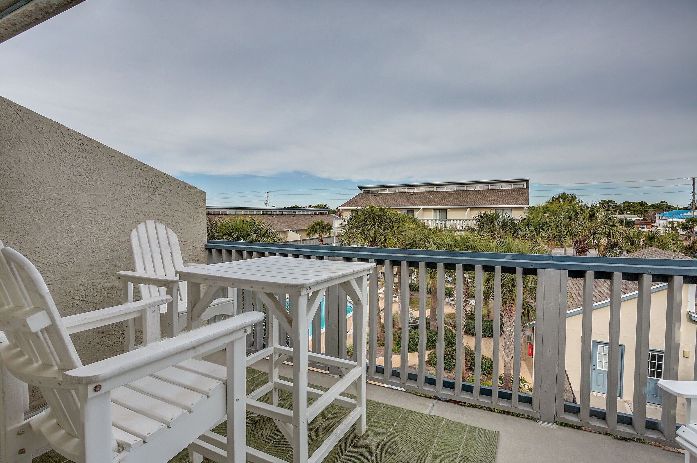 Deck off the master overlooking the lush grounds and pool area.