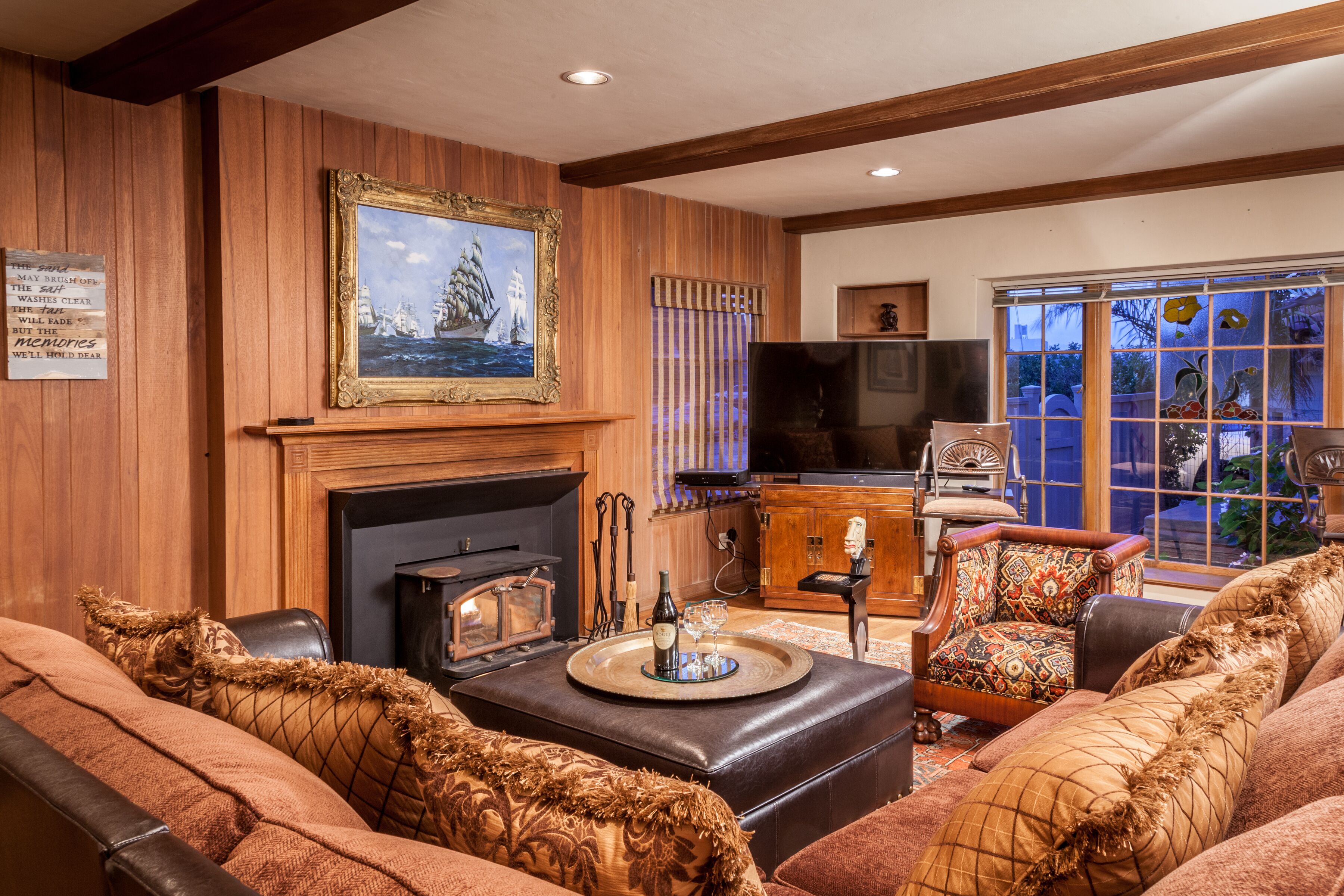 A cozy living room with a fireplace, comfortable seating, and a television.