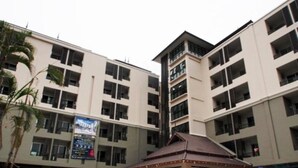 A multi-story hotel with a central atrium, balconies, and a small pavilion with a tiled roof. - L Residence Songkhla (Songkhla)