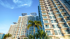 A high-rise building with multiple balconies and a clear sky. - CSuites at 8 Newtown Residences (Lapu-Lapu)