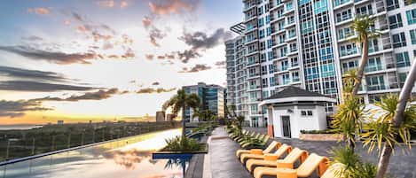 Outdoor pool, open 6:00 AM to 10:00 PM, pool umbrellas, sun loungers