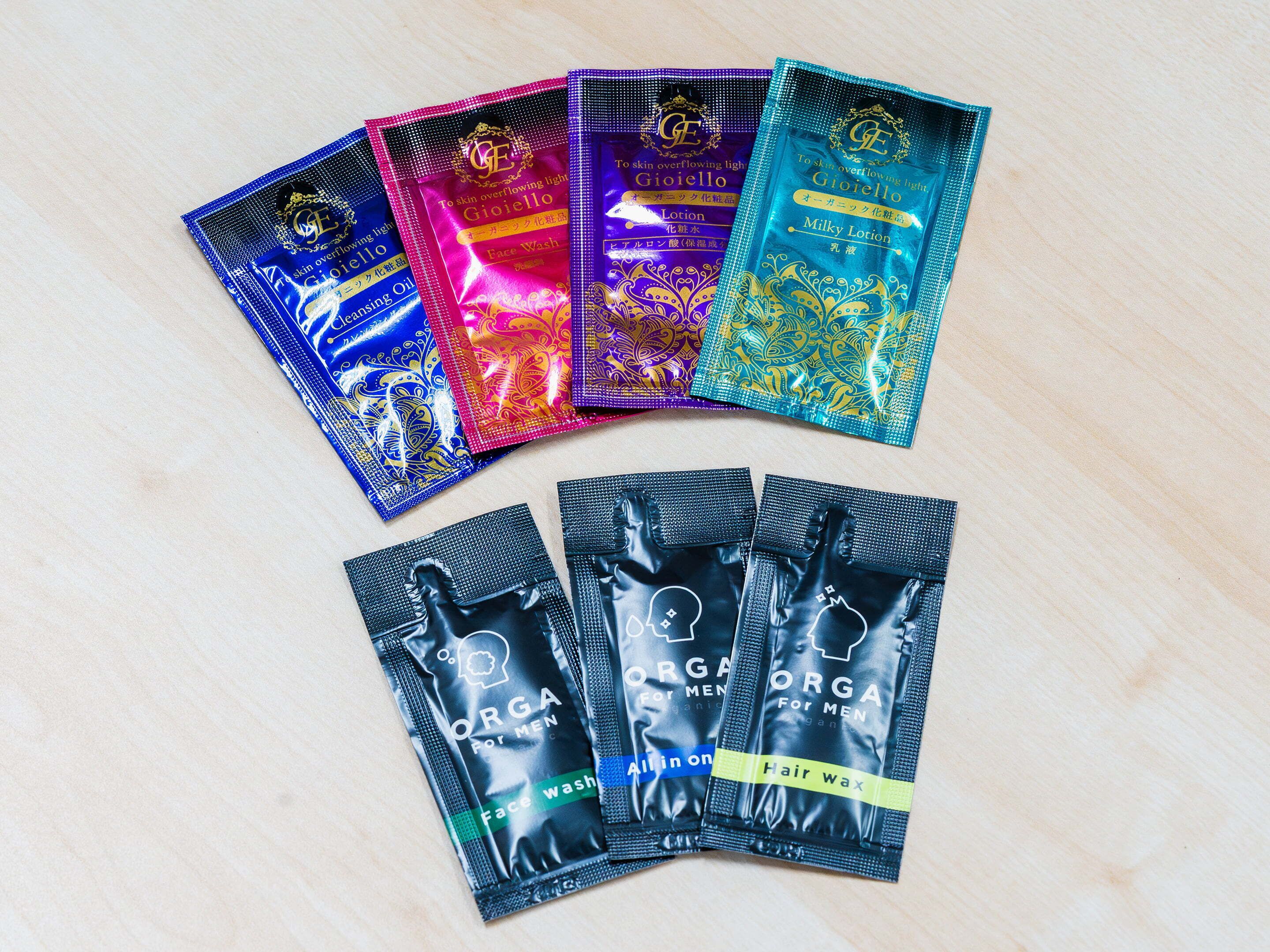 A variety of cosmetic products arranged on a wooden surface.