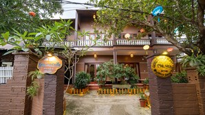 A traditional villa with a wooden balcony, potted plants, and a sign indicating it is a Gold Coast villa. - An Bang Gold Coast Villa (Da Nang)
