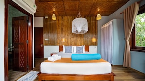 A bedroom with a wooden bed, a bedside table, a hanging light fixture, and a window with curtains. - An Bang Gold Coast Villa (Da Nang)