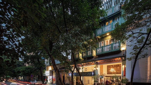 A traditional building with multiple stories, a sign for 'Hanoian Central Hotel & Spa,' and a street with light trails indicating traffic. - Hanoian Central Hotel & Spa (Hanoi)