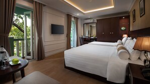 A hotel room with a large bed, a desk, a TV, and a balcony with curtains. - Hanoian Central Hotel & Spa (Hanoi)