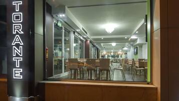 A restaurant with a glass facade and a sign reading "RISTORANTE".