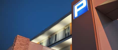 A building with a prominent 'P' sign indicating parking, suggesting a parking facility or area nearby.