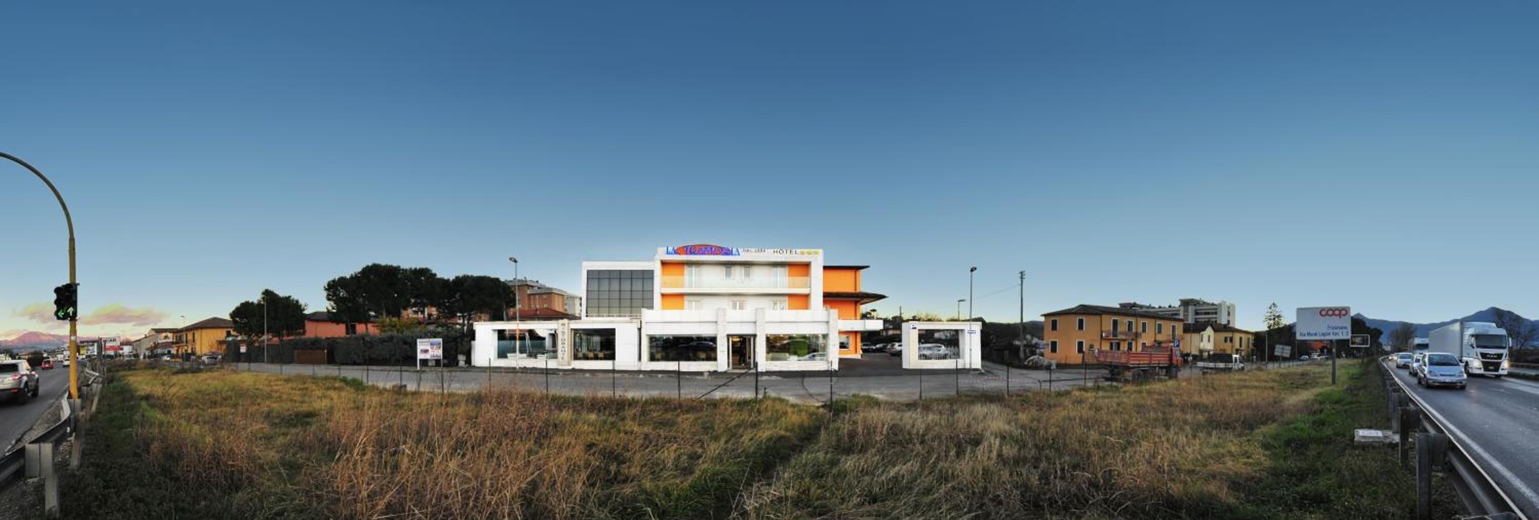 A hotel with a modern design, featuring a prominent orange and white color scheme.