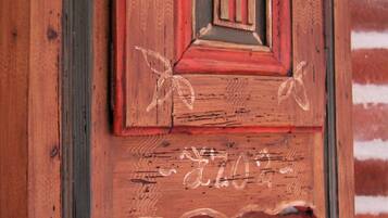 A wooden door with carved figures and a decorative panel.