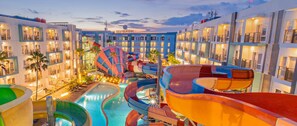 A hotel with multiple swimming pools and water slides, surrounded by multi-story buildings. - Astara Hotel Balikpapan (Balikpapan)