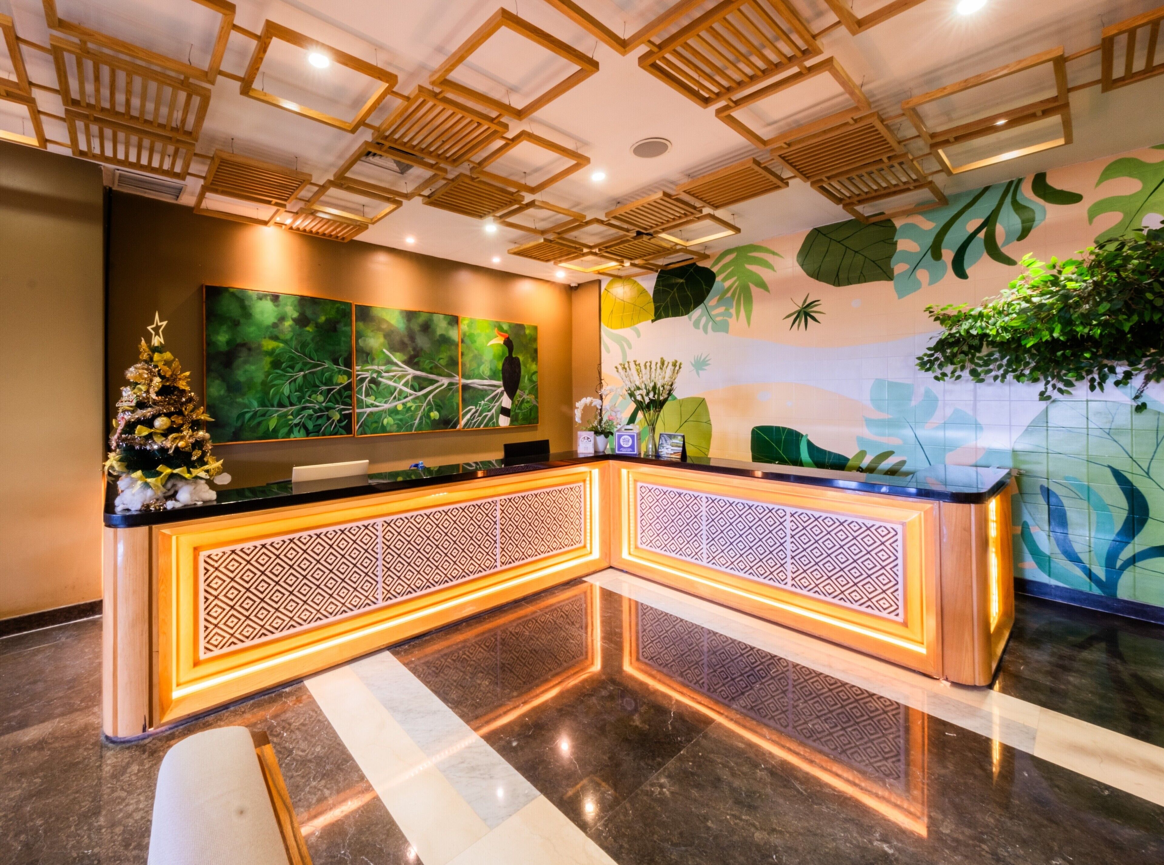 A reception area with a wooden ceiling, a Christmas tree, and a large wall mural.
