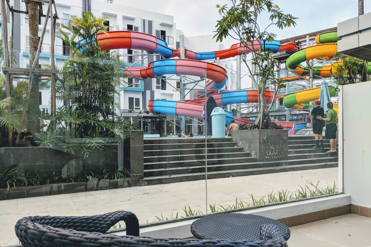 Een waterpark met glijbanen en trappen die naar het water leiden.