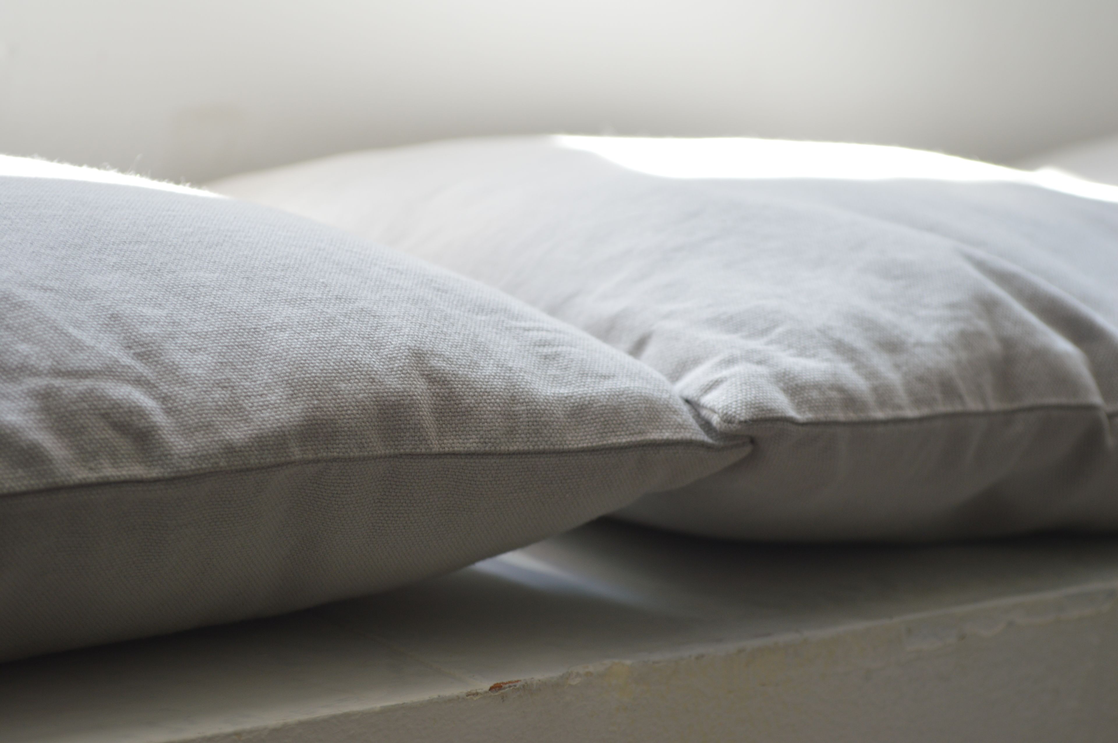 A close-up of two pillows on a bed.